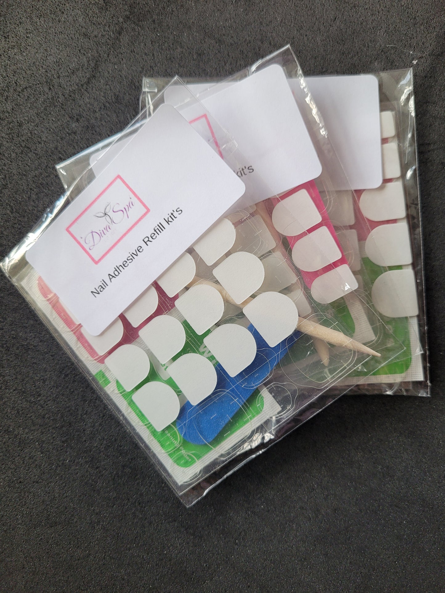 Nail adhesive refill kit