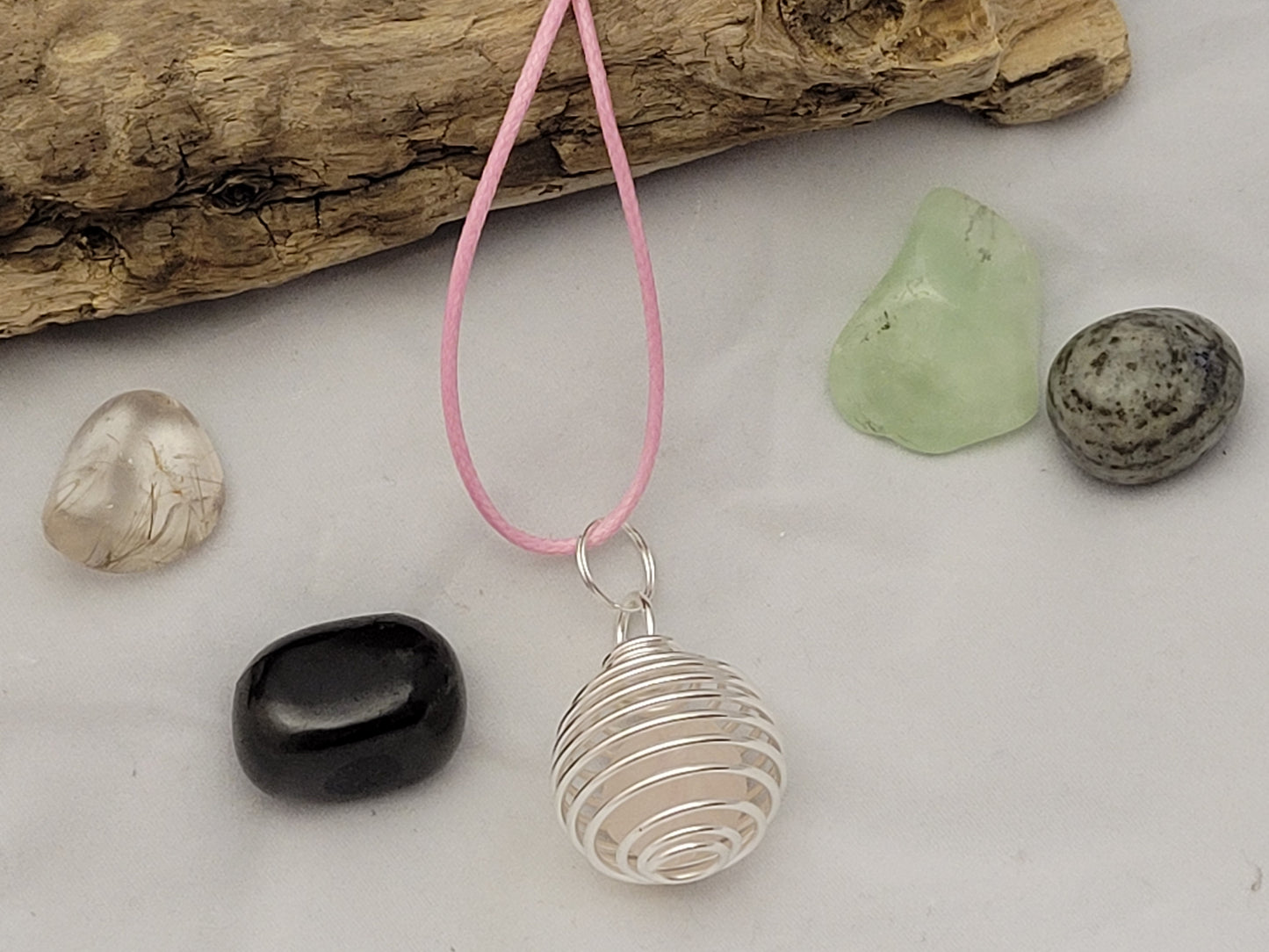 Rose quartz gemstone caged necklace..
